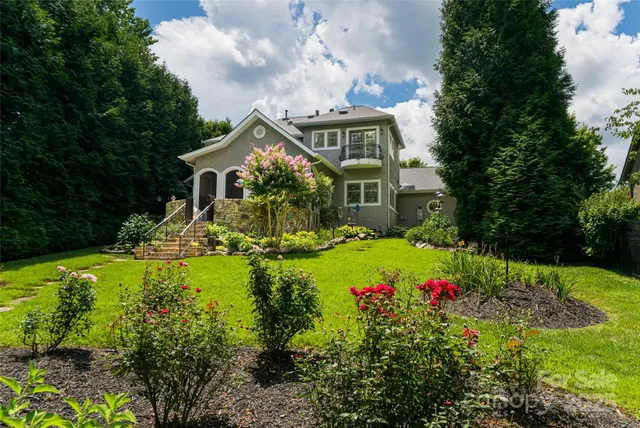a front view of a house with a yard and fountain