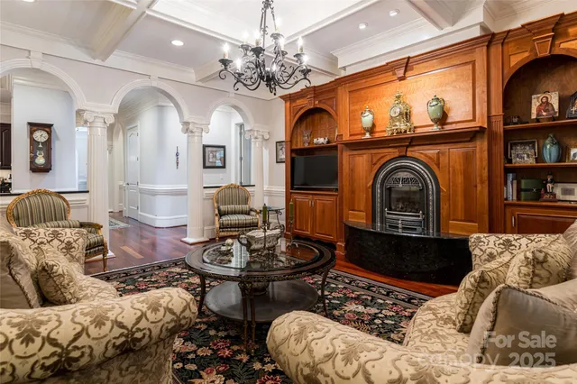 a living room with furniture a rug and white walls