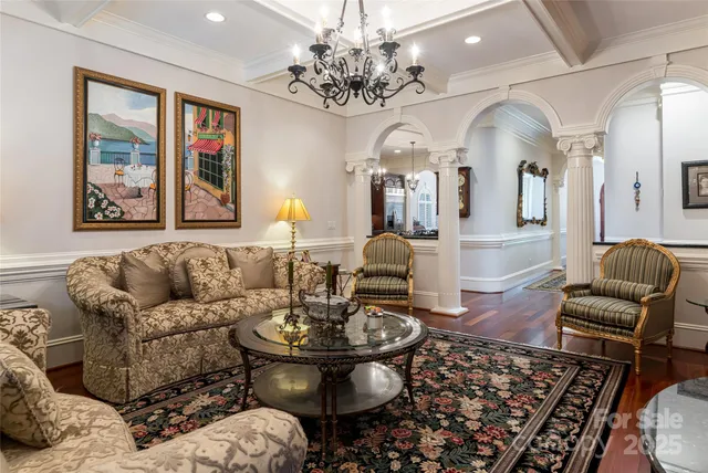 a living room with furniture and a chandelier