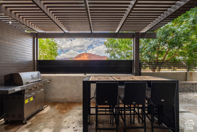 2600 Ocotillo Way, Unit 34 Santa Clara, UT 84765 - Photo 36 of 43 View of patio featuring area for grilling, a mountain view, outdoor dining area, and a pergola