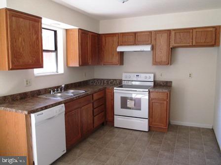 32075 Melson Road Delmar, MD 21875 - Photo 3 of 12 a kitchen with a stove sink and cabinets