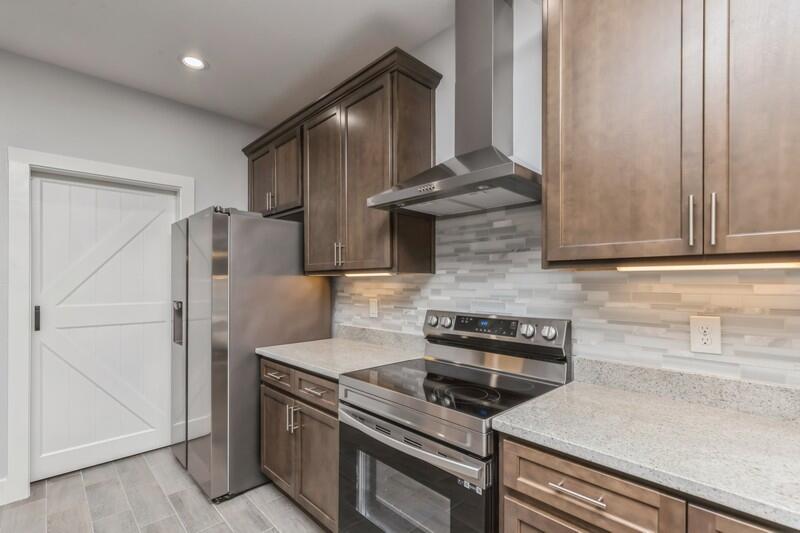 4516 Hermosa Road Crestview, FL 32539 - Photo 11 of 35 a kitchen with granite countertop a stove and a refrigerator