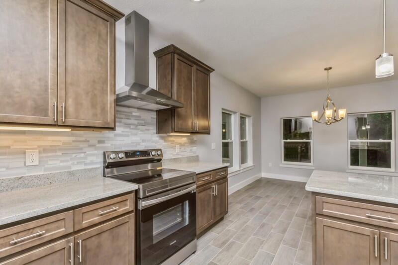 4516 Hermosa Road Crestview, FL 32539 - Photo 13 of 35 a kitchen with stainless steel appliances granite countertop a stove and a sink