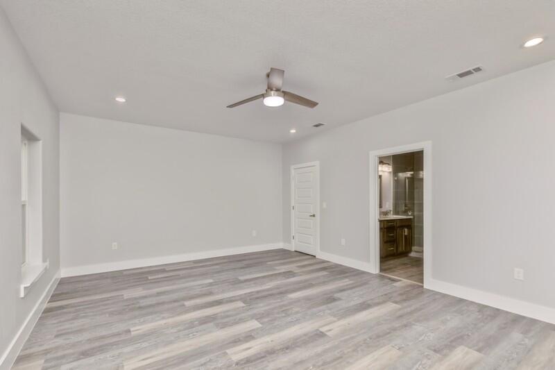 4516 Hermosa Road Crestview, FL 32539 - Photo 17 of 35 wooden floor in an empty room with a window