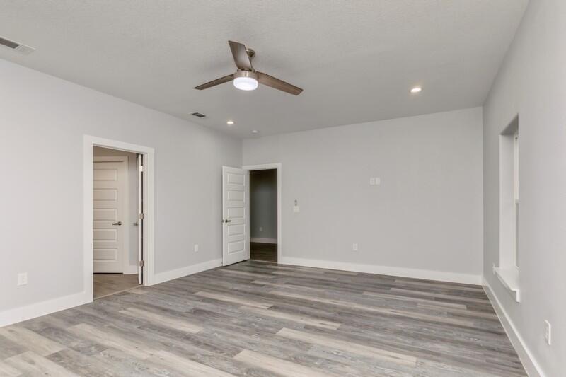 4516 Hermosa Road Crestview, FL 32539 - Photo 18 of 35 an empty room with wooden floor fan and windows