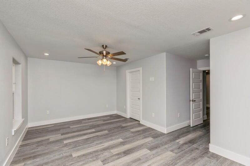4516 Hermosa Road Crestview, FL 32539 - Photo 25 of 35 wooden floor in an empty room with a window