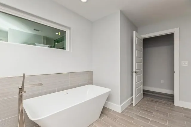 a white bath tub sitting in a bathroom