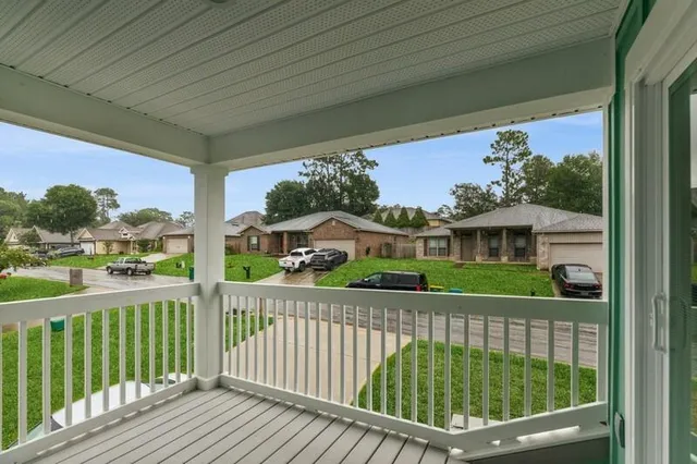 a side view of a house with a porch