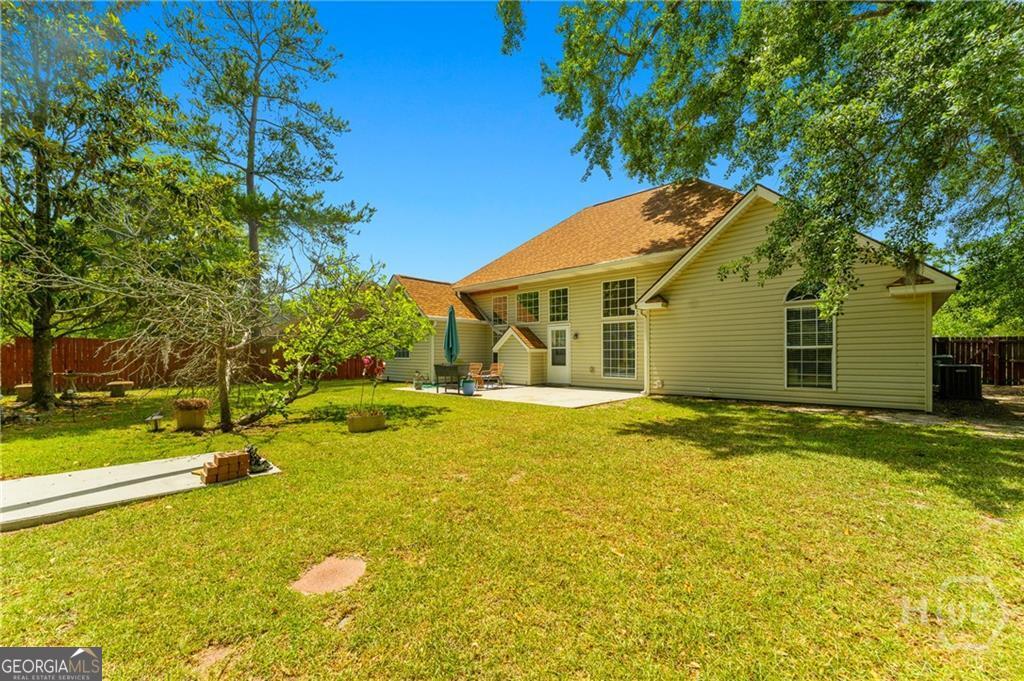 10 Fox Hound Court Pooler, GA 31322 - Photo 27 of 32 a view of a house with swimming pool and a yard