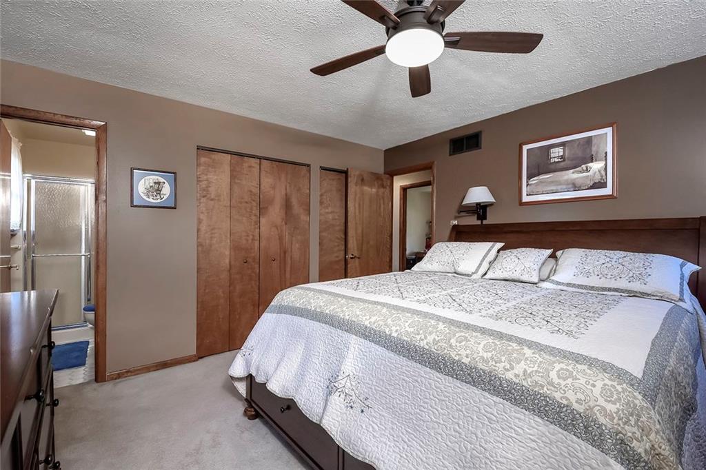 201 County Line Road Bridgeville, PA 15017 - Photo 14 of 25 Spacious Master Bedroom with neutral carpeting, large closets, and ceiling fan with light.