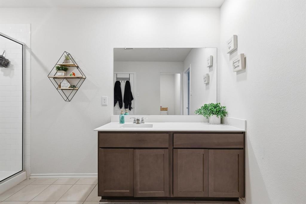 2416 Wildhaven Road Crandall, TX 75114 - Photo 19 of 35 a bathroom with a sink and a mirror