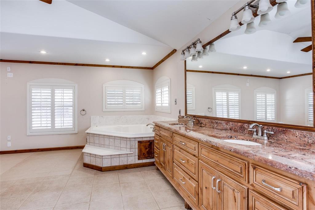 9470 S Highway Pilot Point, TX 76258 - Photo 14 of 26 a spacious bathroom with a granite countertop double vanity sink a large mirror and bathtub