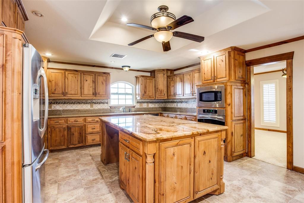 9470 S Highway Pilot Point, TX 76258 - Photo 5 of 26 a kitchen with stainless steel appliances granite countertop a sink stove and refrigerator