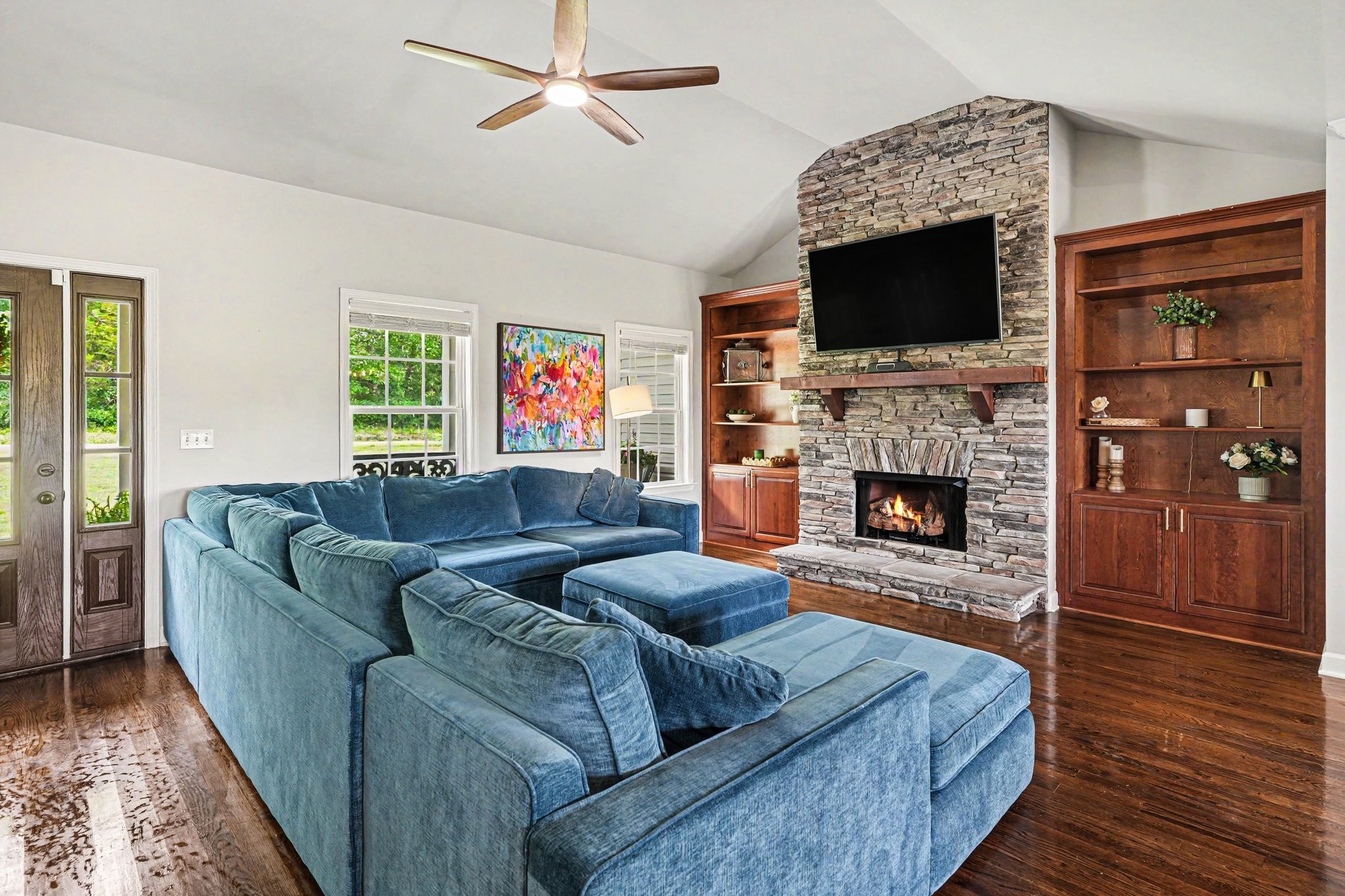 948 Goslin Branch Road Burns, TN 37029 - Photo 3 of 37 a living room with furniture a flat screen tv and a fireplace