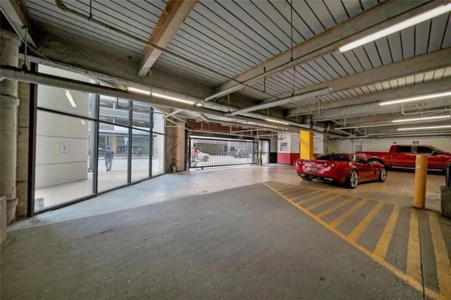 a view of parking garage with cars