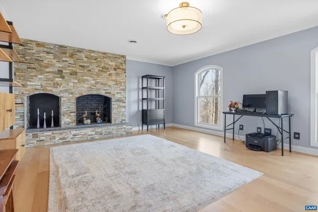 a view of a backyard with table and chairs potted plants and large tree
