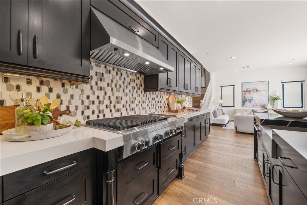 143 Ceremony Irvine, CA 92618 - Photo 16 of 74 a kitchen with stainless steel appliances granite countertop a stove and a sink