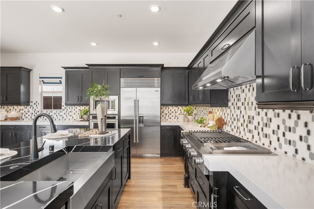 143 Ceremony Irvine, CA 92618 - Photo 17 of 74 a kitchen with stainless steel appliances granite countertop a sink stove and refrigerator
