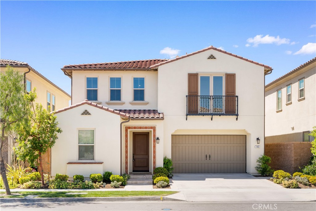 143 Ceremony Irvine, CA 92618 - Photo 2 of 74 a front view of a house with a yard and garage