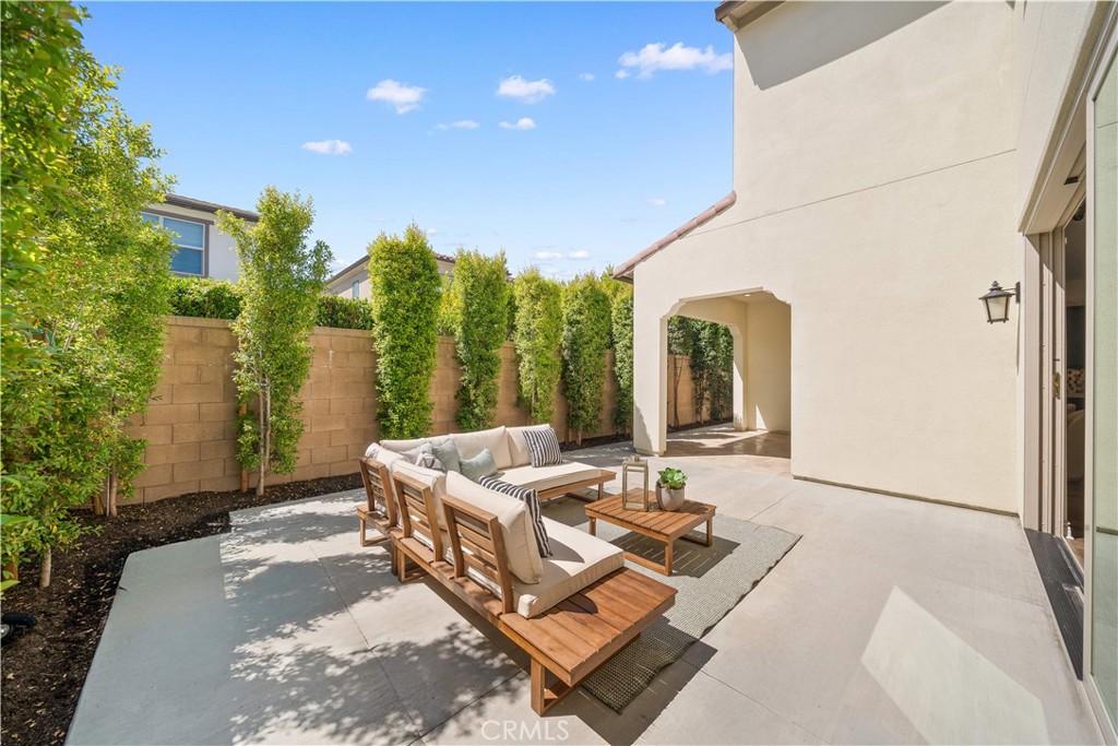 143 Ceremony Irvine, CA 92618 - Photo 26 of 74 a view of a patio with couches and table and chairs and potted plants