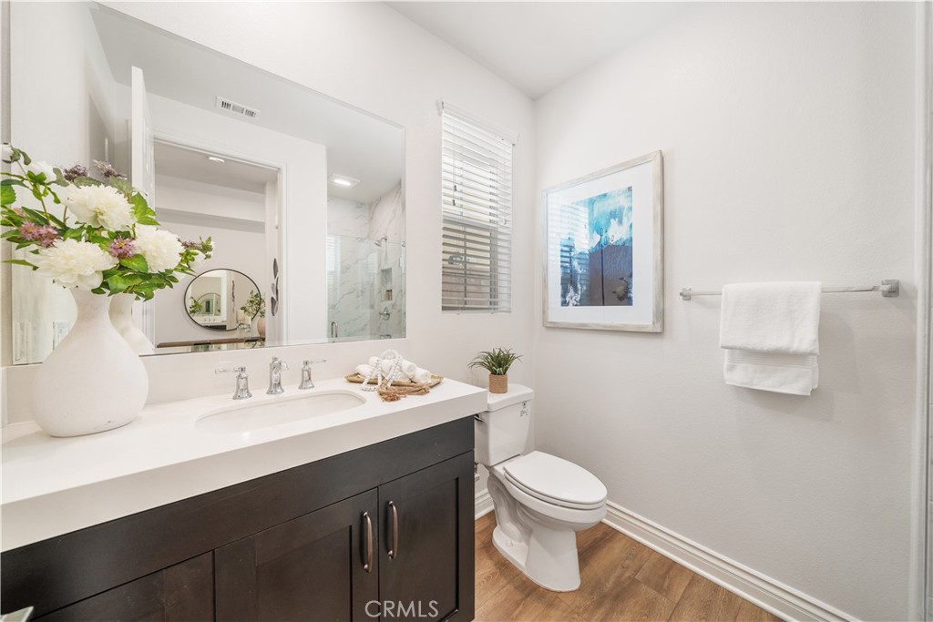 143 Ceremony Irvine, CA 92618 - Photo 29 of 74 a bathroom with a toilet sink and mirror