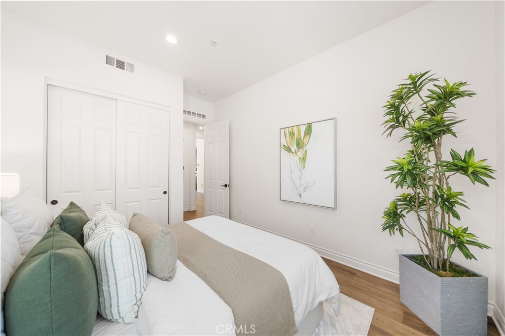 143 Ceremony Irvine, CA 92618 - Photo 32 of 74 a bedroom with a bed and a potted plant