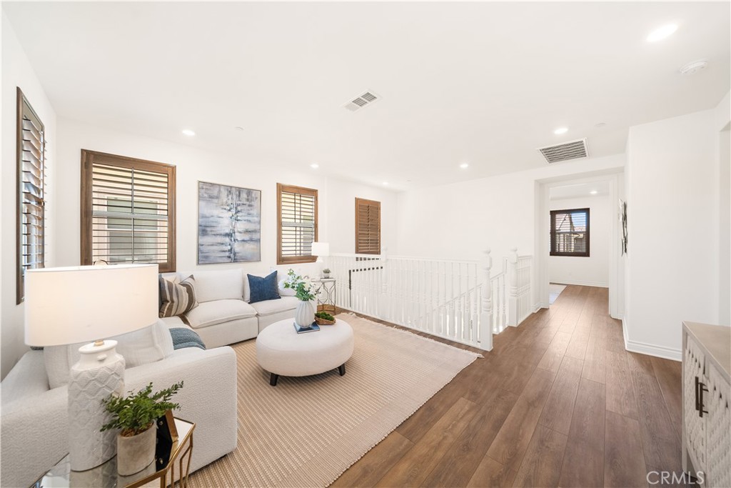 143 Ceremony Irvine, CA 92618 - Photo 35 of 74 a living room with furniture and wooden floor