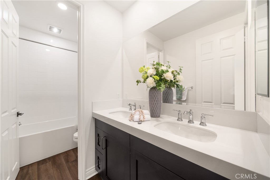 143 Ceremony Irvine, CA 92618 - Photo 38 of 74 a bathroom with a sink and a mirror