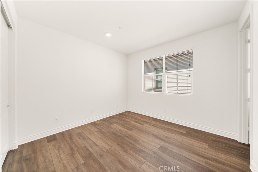 143 Ceremony Irvine, CA 92618 - Photo 40 of 74 an empty room with wooden floor and windows