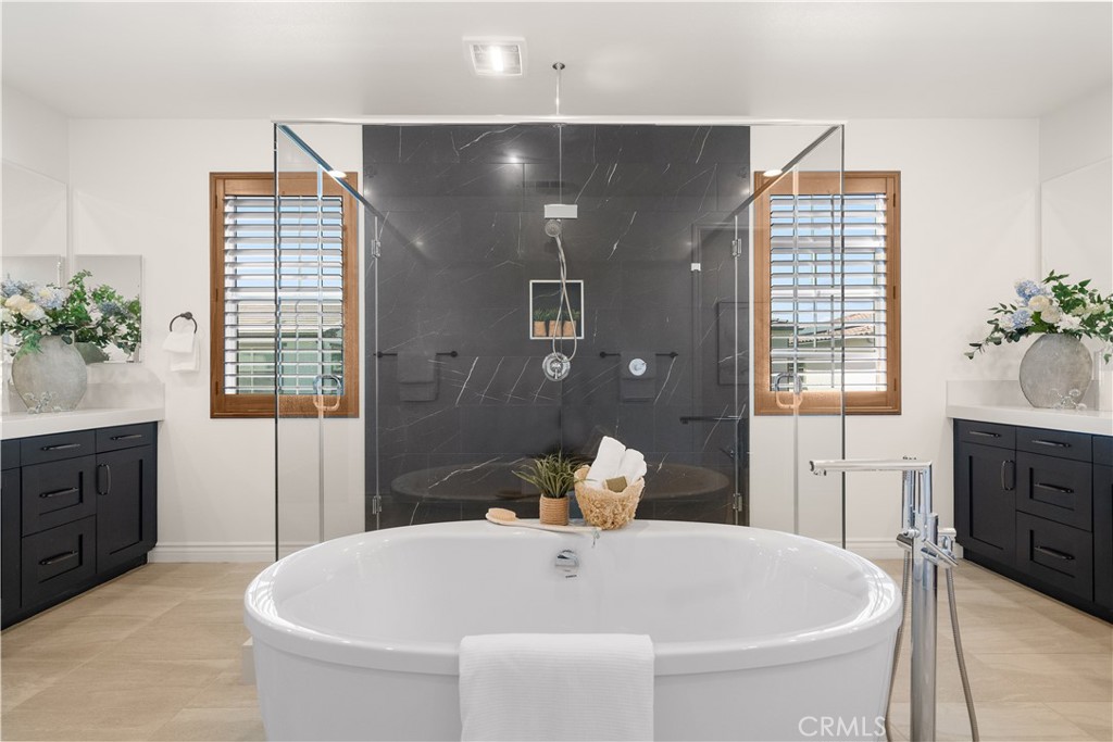 143 Ceremony Irvine, CA 92618 - Photo 50 of 74 a white bath tub sitting in a bathroom and mirror