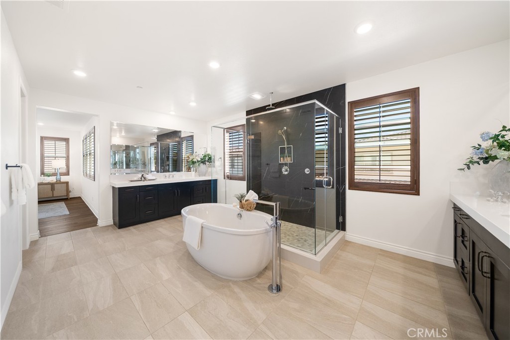 143 Ceremony Irvine, CA 92618 - Photo 51 of 74 a spacious bathroom with a double vanity sink tub and mirror