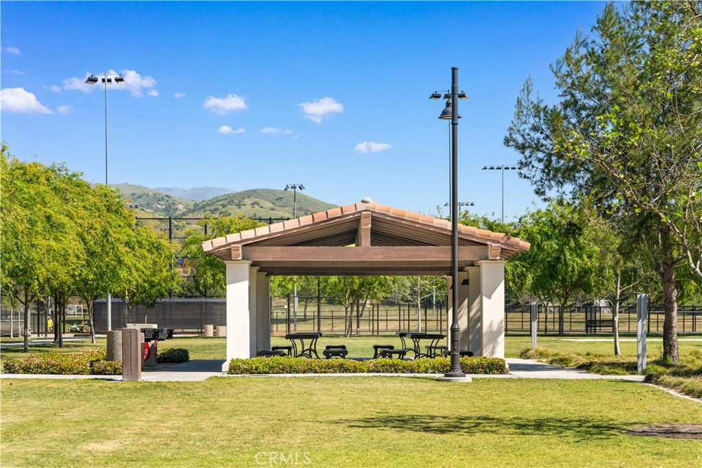 143 Ceremony Irvine, CA 92618 - Photo 69 of 74 a view of a swimming pool with a lawn chairs under an umbrella