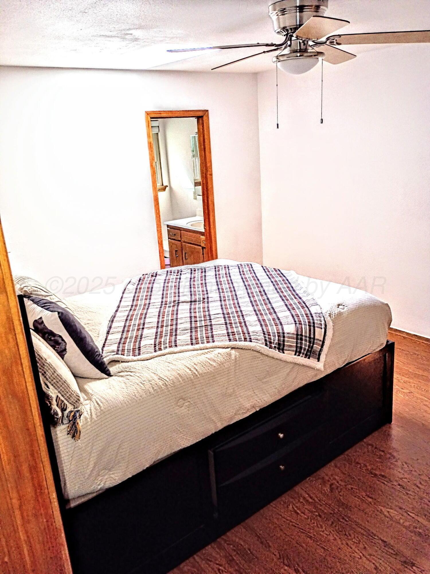 3100 Janet Drive Amarillo, TX 79109 - Photo 11 of 22 a bedroom with a bed and wooden floor