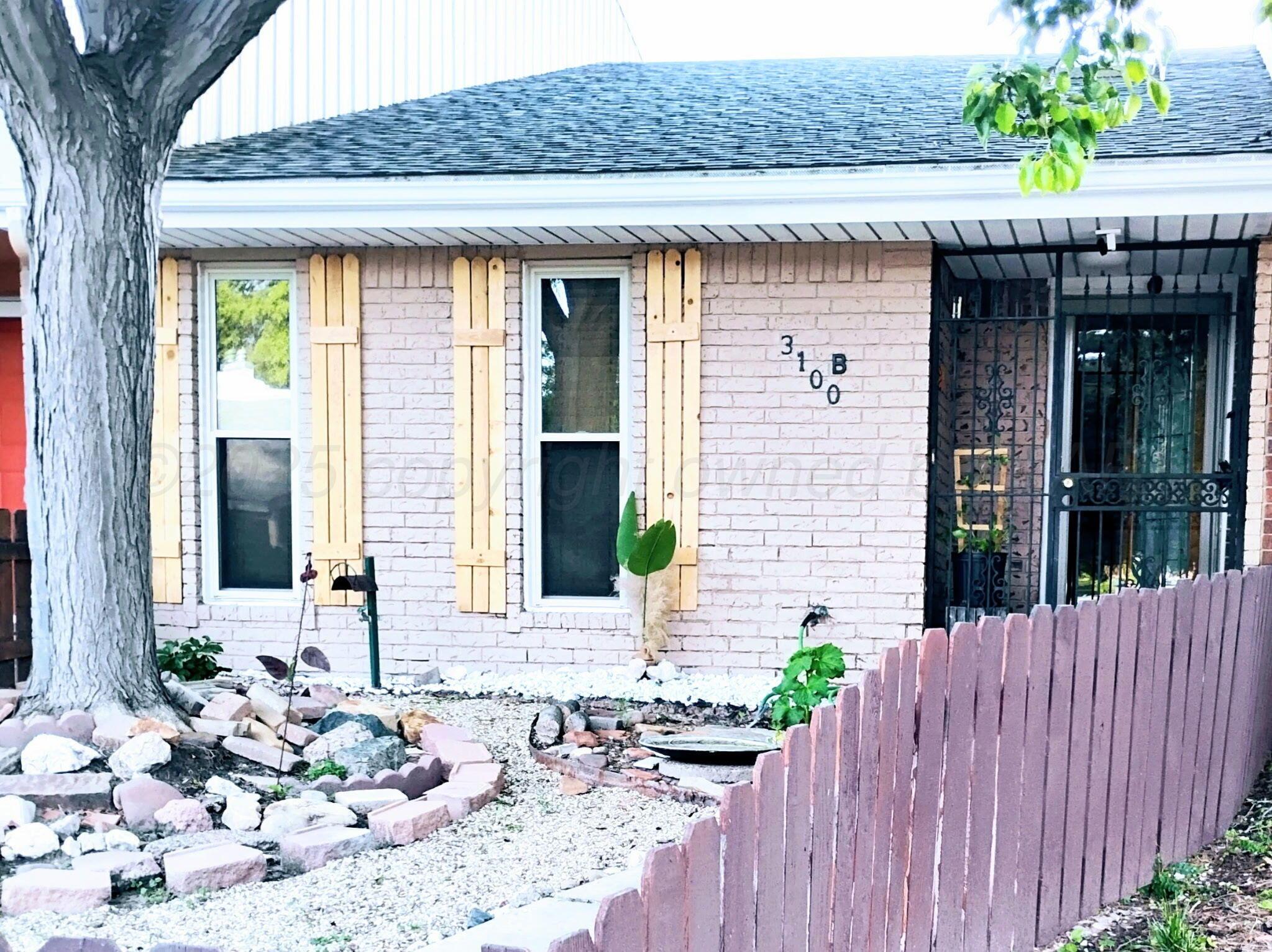 3100 Janet Drive Amarillo, TX 79109 - Photo 3 of 22 a front view of a house with a garden