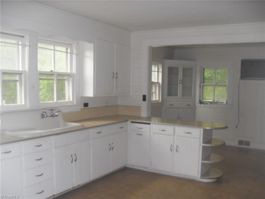 1410 Holly Grove Road Lexington, NC 27292 - Photo 3 of 28 A great farm house kitchen that takes you back in time. This kitchen has a breakfast area with built in china cabinet.