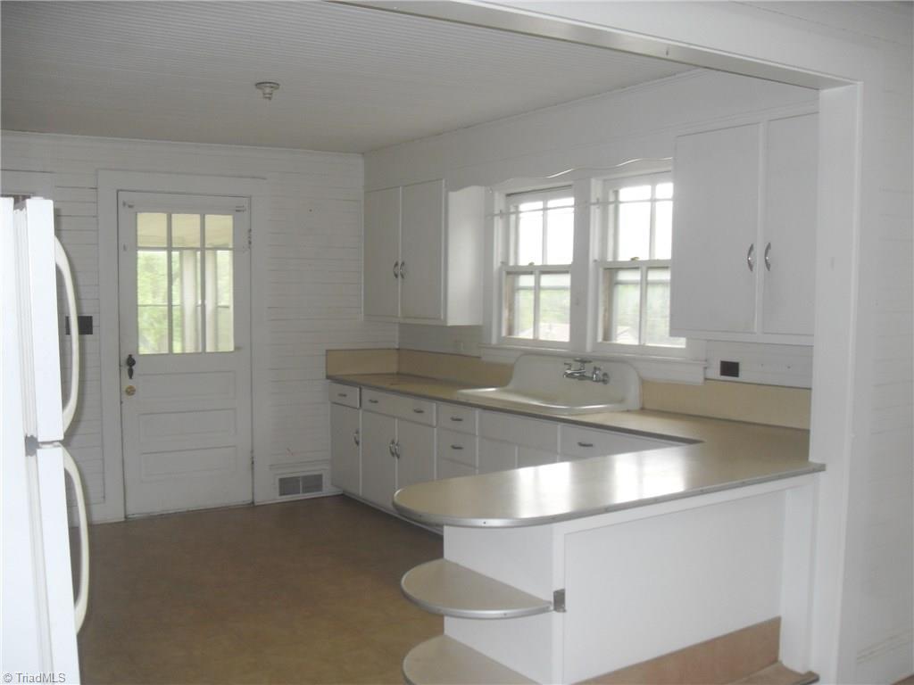 1410 Holly Grove Road Lexington, NC 27292 - Photo 4 of 28 Solid wood cabinets and large windows that let natural light in.