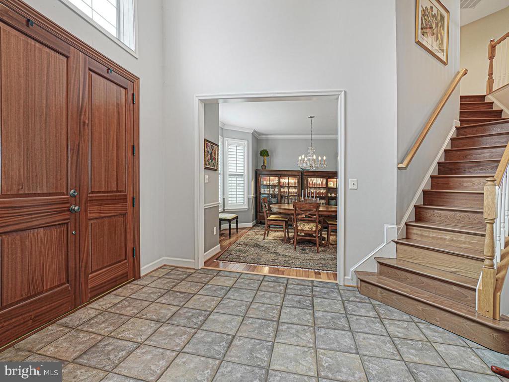 Welcoming foyer with mahogony doors.