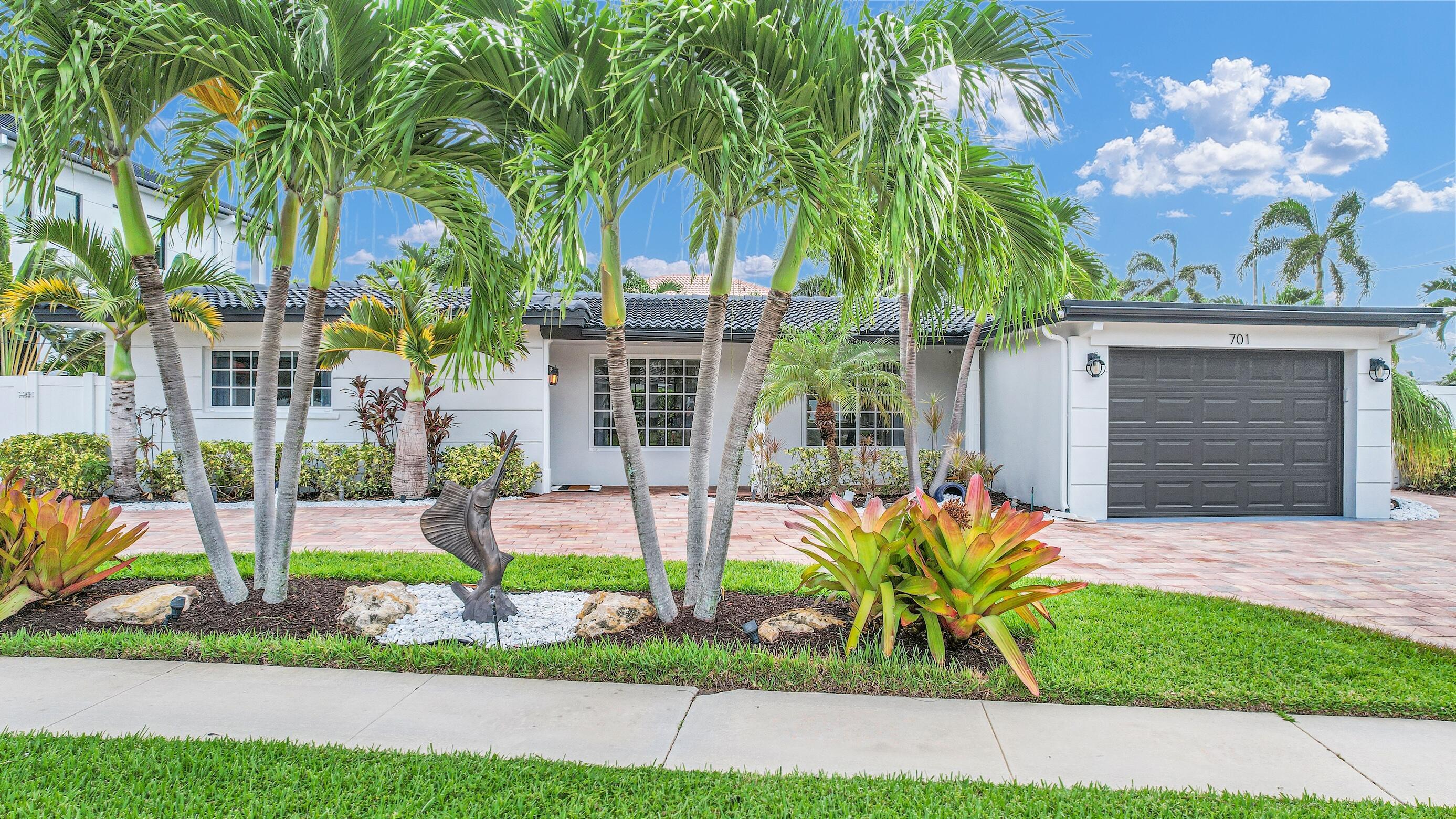 701 Appleby Street Boca Raton, FL 33487 - Photo 4 of 47 a front view of a house with a garden and plants