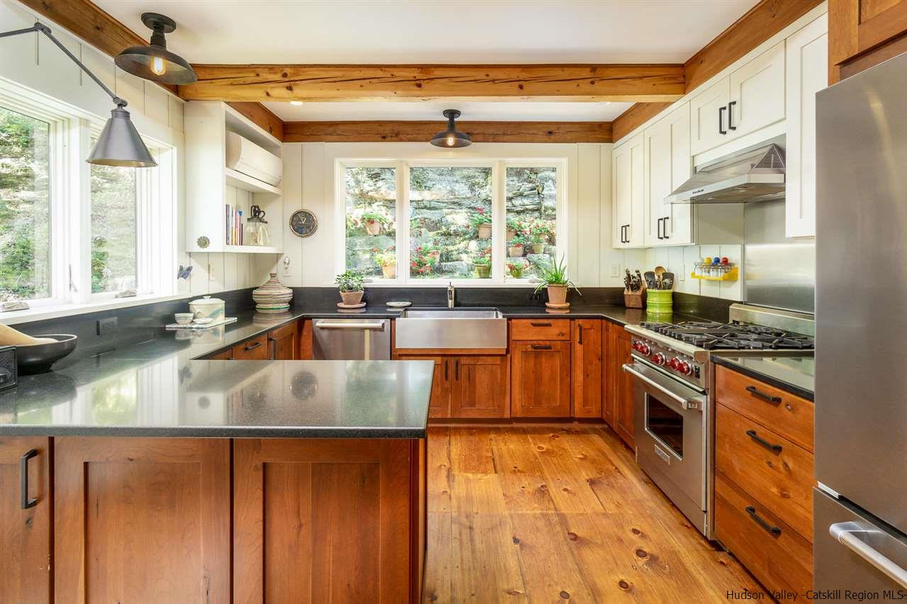 45 Pratt Road Stone Ridge, NY 12484 - Photo 25 of 35 a kitchen with stainless steel appliances granite countertop a sink a stove and a wooden floors