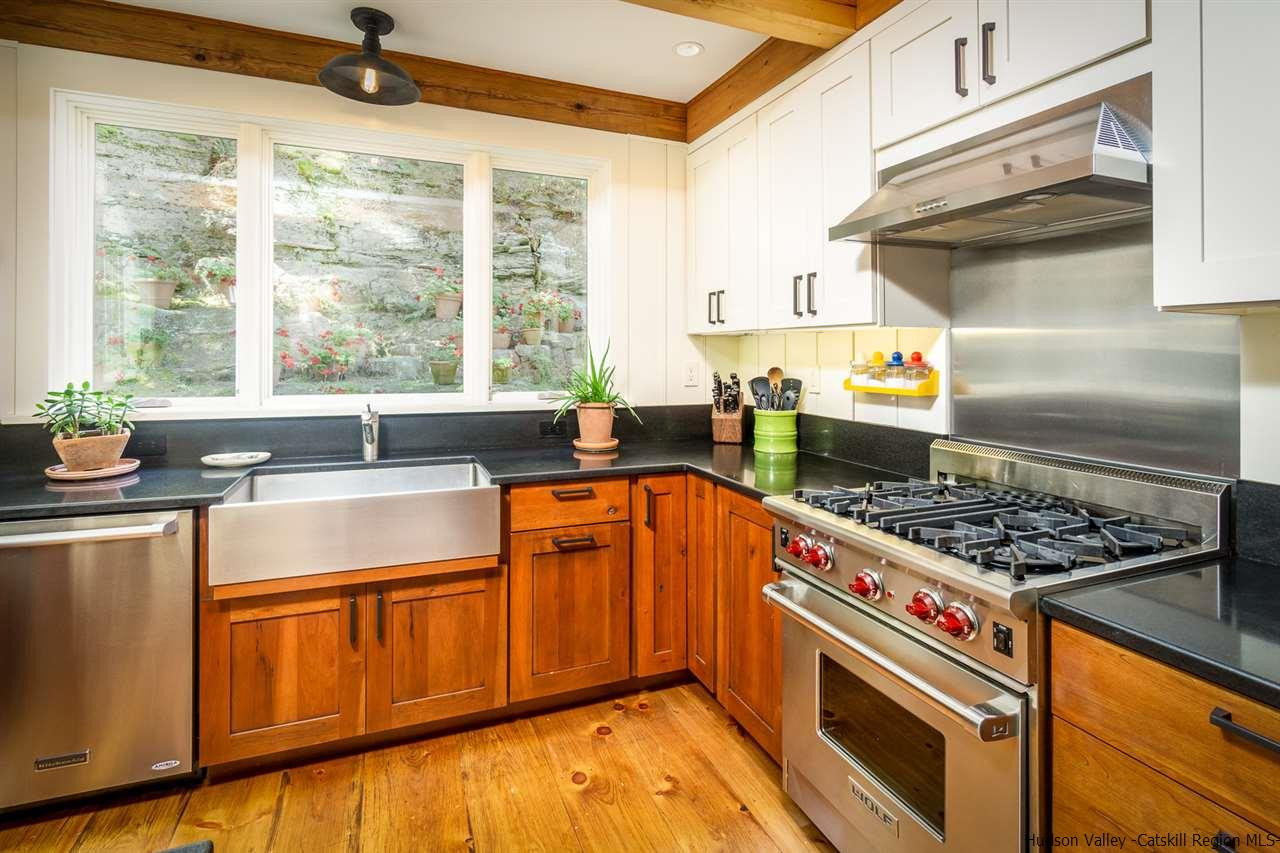 45 Pratt Road Stone Ridge, NY 12484 - Photo 26 of 35 a kitchen with stainless steel appliances granite countertop a sink stove and refrigerator