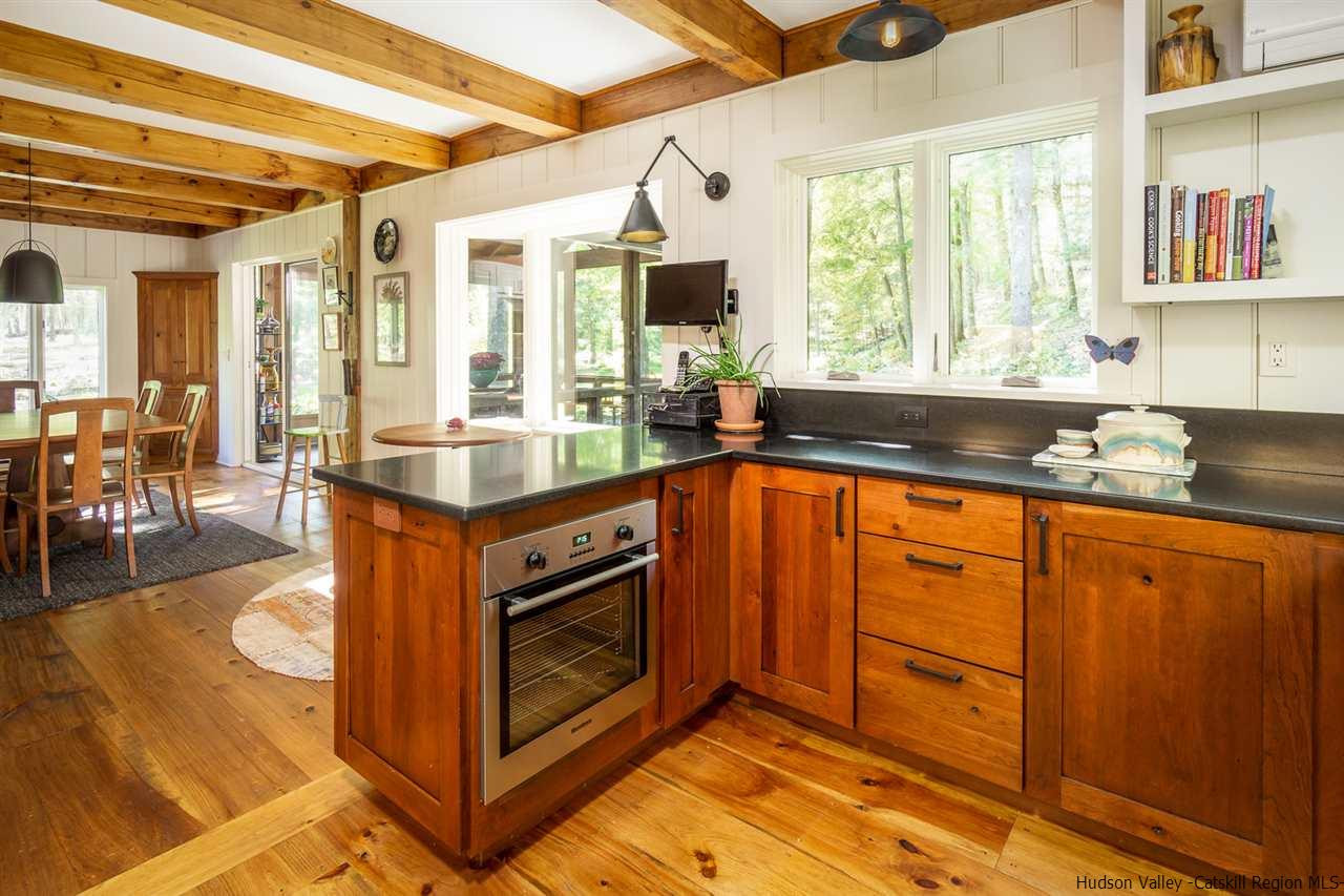 45 Pratt Road Stone Ridge, NY 12484 - Photo 27 of 35 a kitchen with granite countertop a stove a sink and a cabinets
