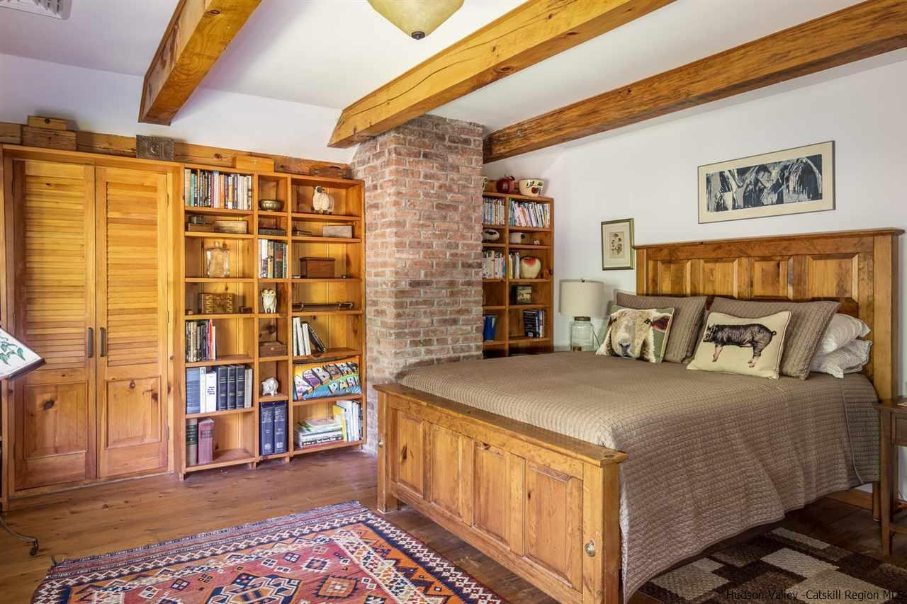 45 Pratt Road Stone Ridge, NY 12484 - Photo 34 of 35 a bedroom with a bed and a table