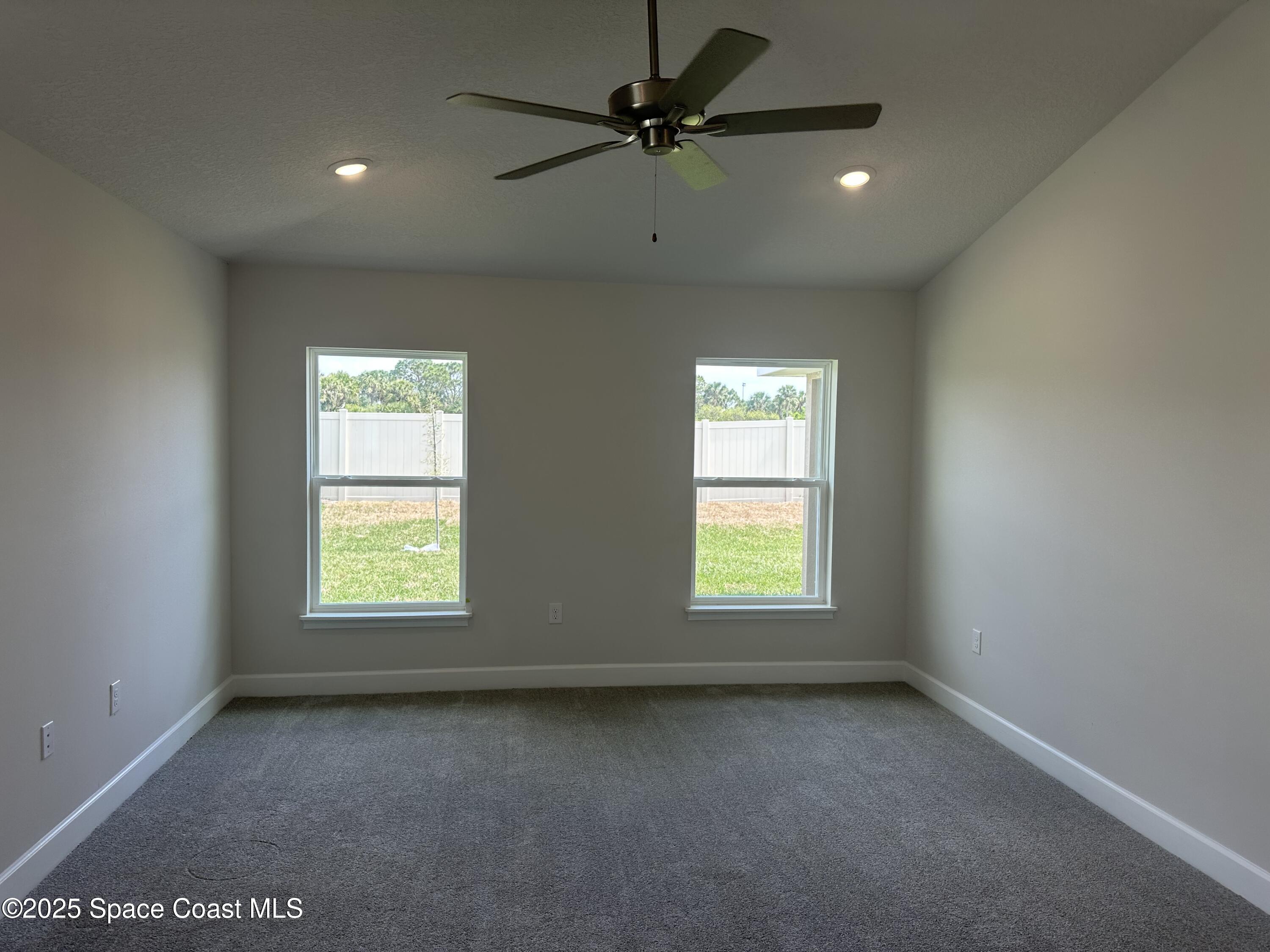 915 Kylar Drive Palm Bay, FL 32907 - Photo 11 of 15 an empty room with a window and a fan