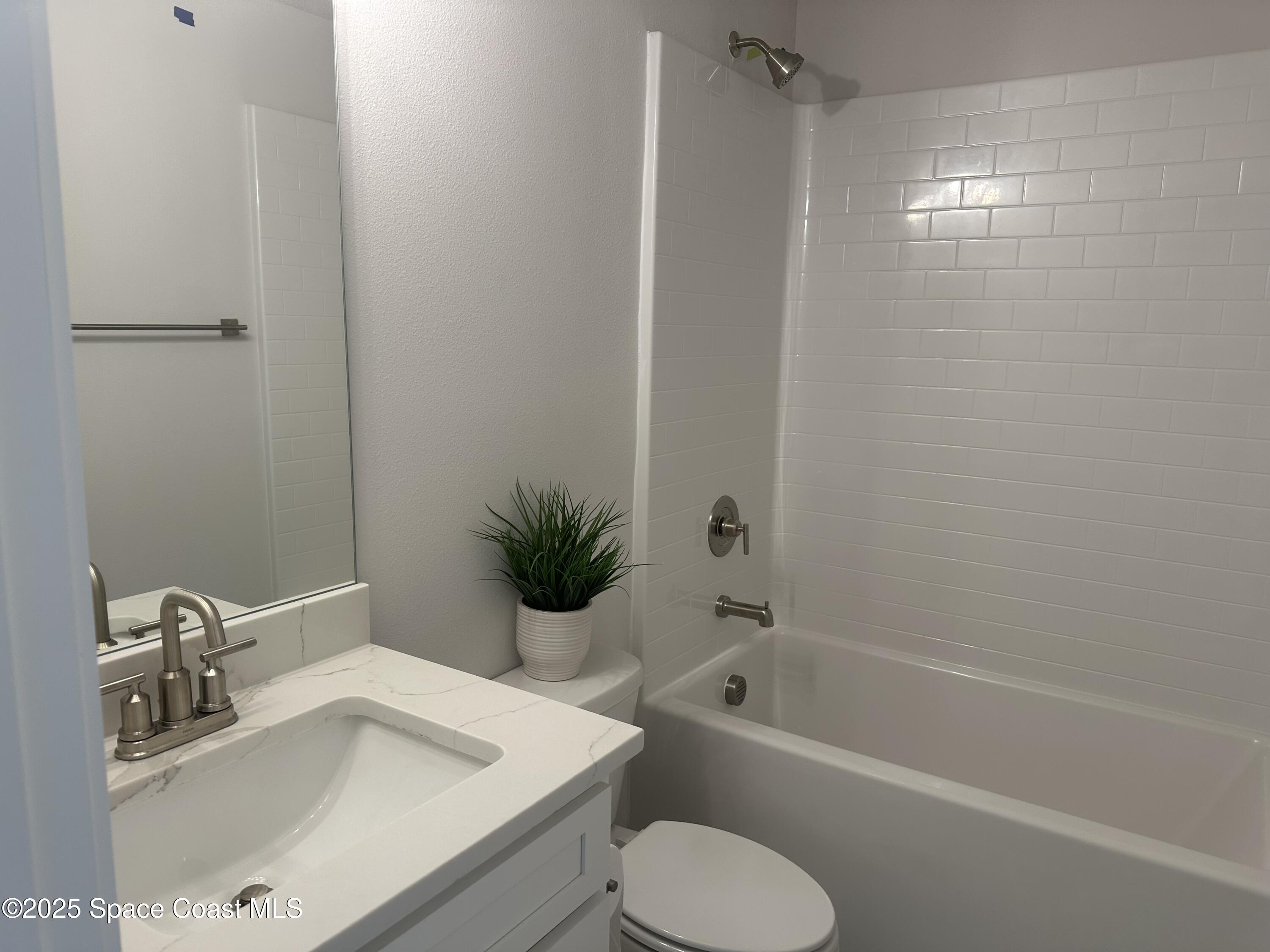 915 Kylar Drive Palm Bay, FL 32907 - Photo 9 of 15 a bathroom with a sink toilet and shower