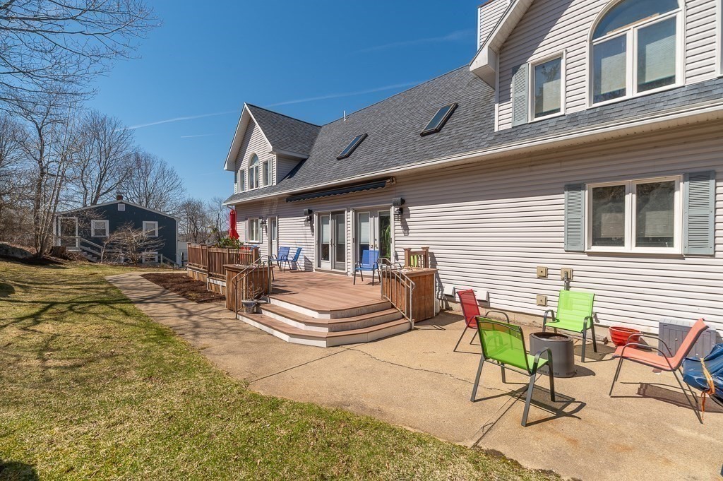 129 Thatcher Road Gloucester, MA 01930 - Photo 25 of 31 a view of a patio with table and chairs and floor to ceiling window