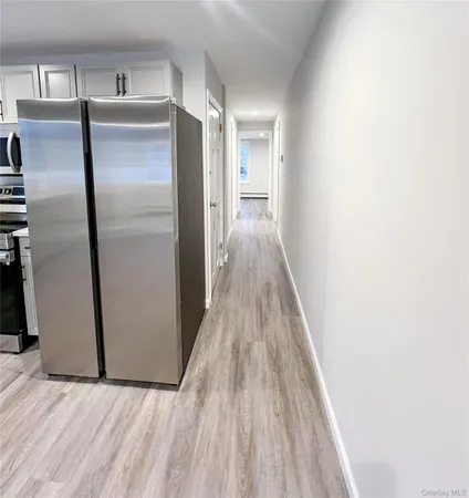 a view of a refrigerator in kitchen and wooden floor