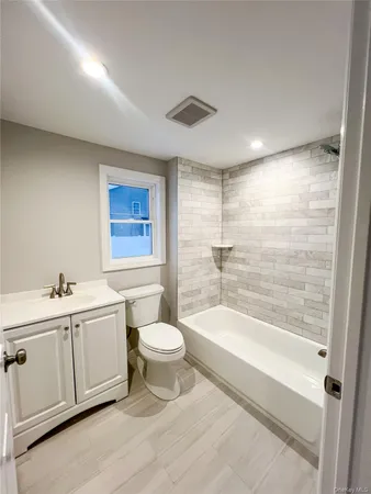 a bathroom with a toilet a sink and bathtub