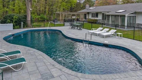 a view of a swimming pool with a patio