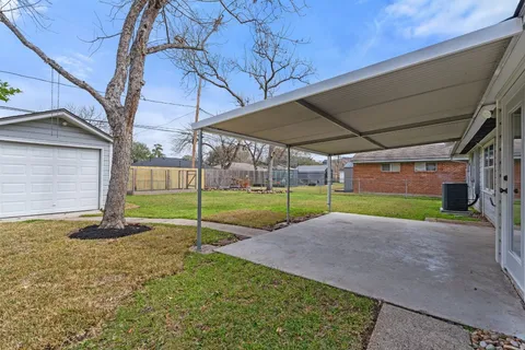 a view of a house with a backyard