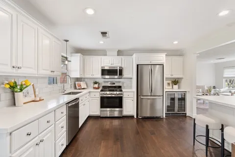 a kitchen with refrigerator a stove top oven and refrigerator